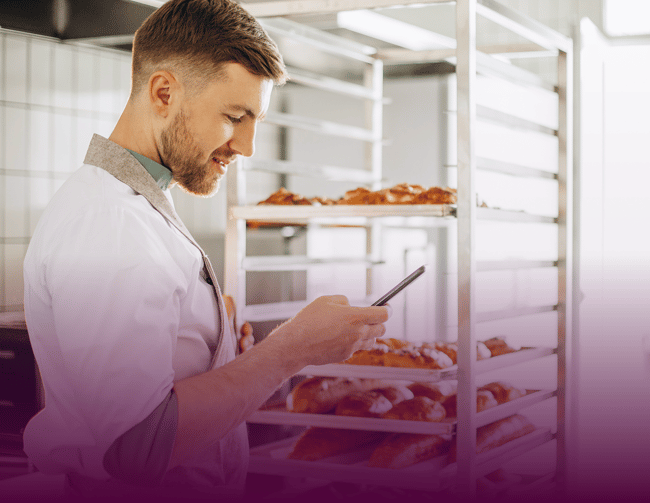 man-baker-kitchen-using-phone 3